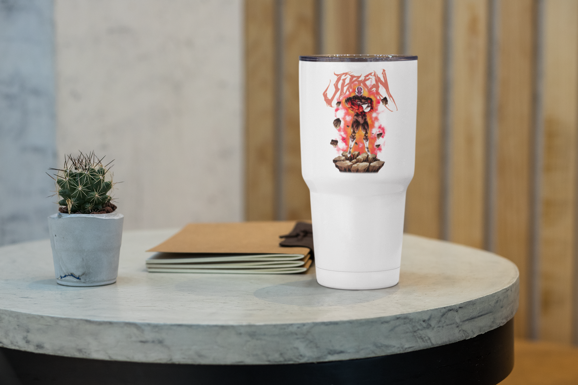 a white cup sitting on top of a table next to a plant