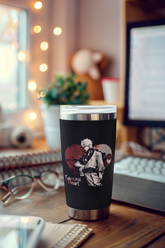 a coffee cup sitting on top of a wooden desk
