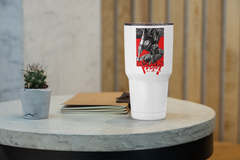 a white cup sitting on top of a table next to a plant
