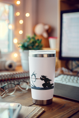 a cup sitting on a desk next to a computer
