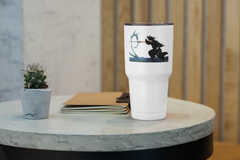 a white coffee cup sitting on top of a table