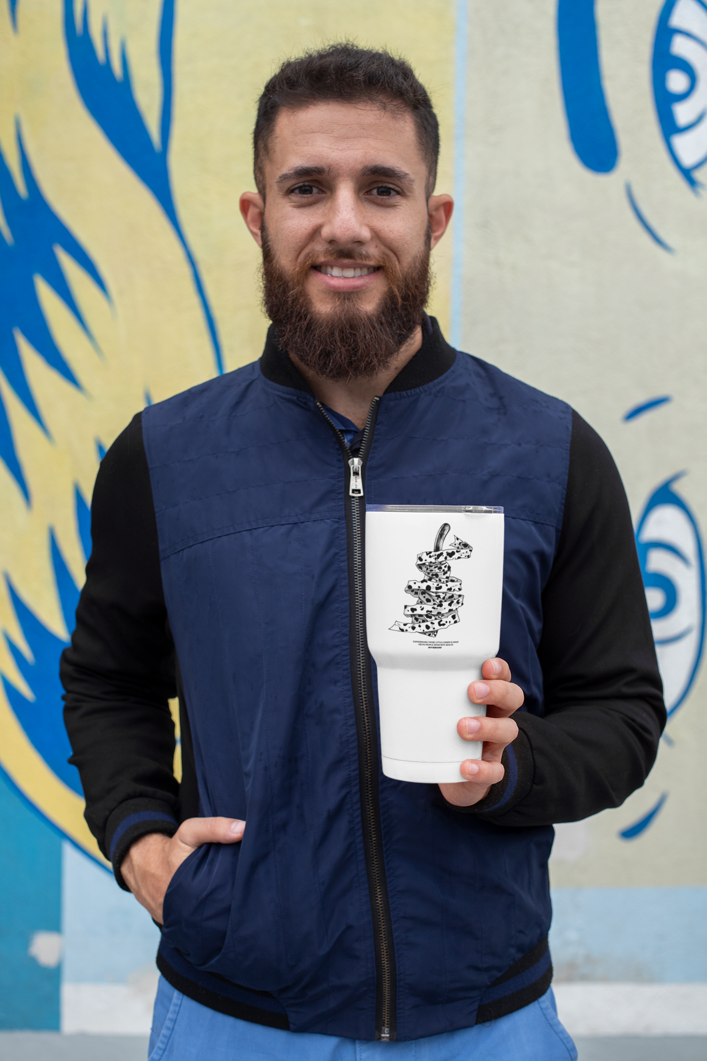 a man with a beard holding a cup of coffee
