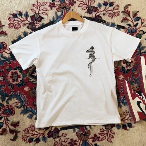 a white t - shirt with a picture of a snake on it