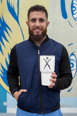 a man with a beard holding a cup of coffee