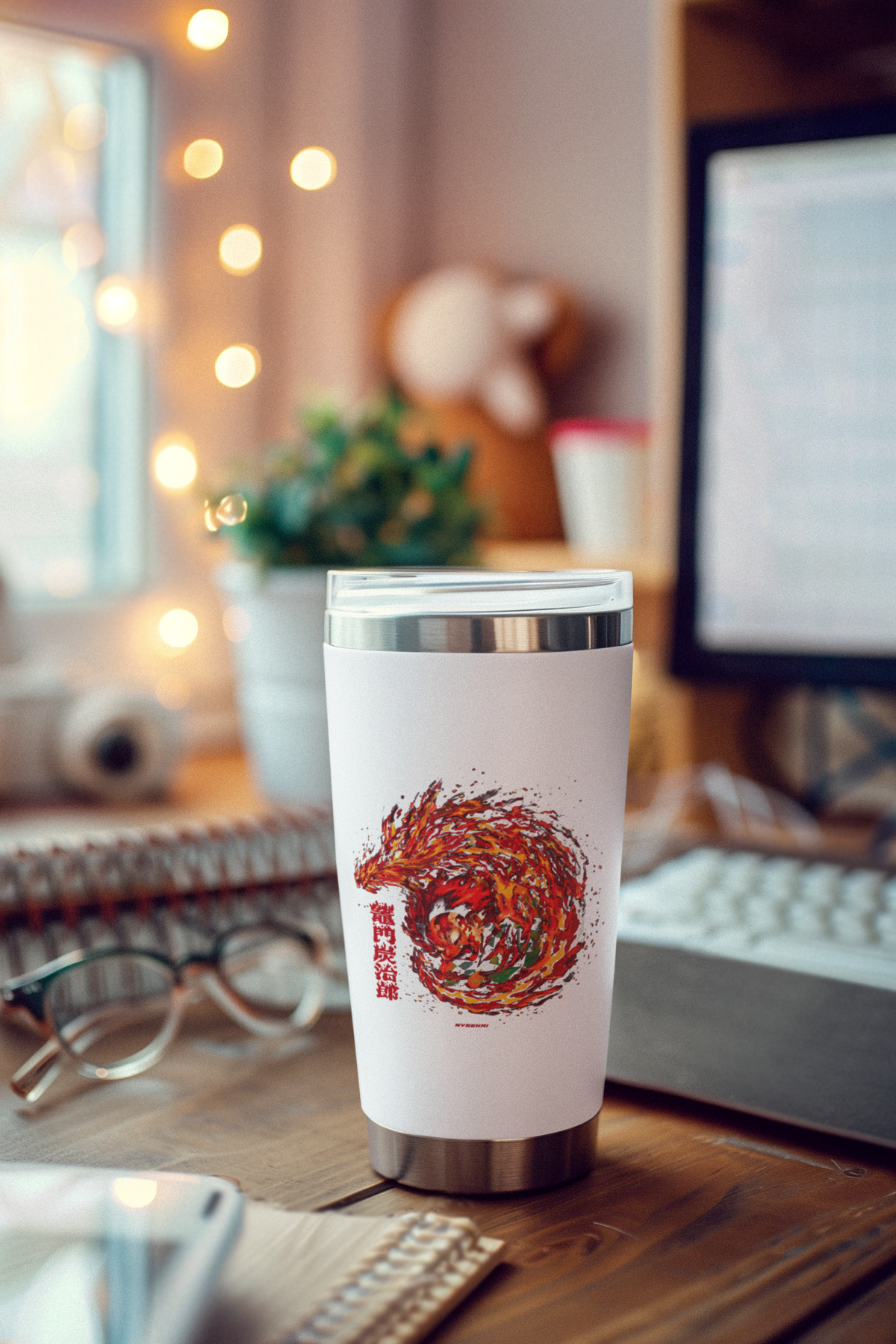 a cup sitting on a desk next to a computer