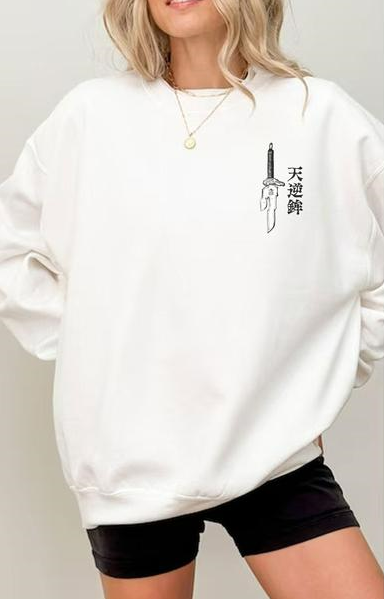 a woman wearing a white sweatshirt and black shorts