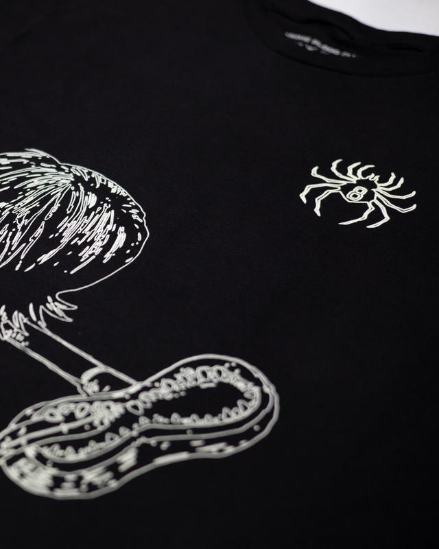 a black t - shirt with a picture of a bird and a spider on it