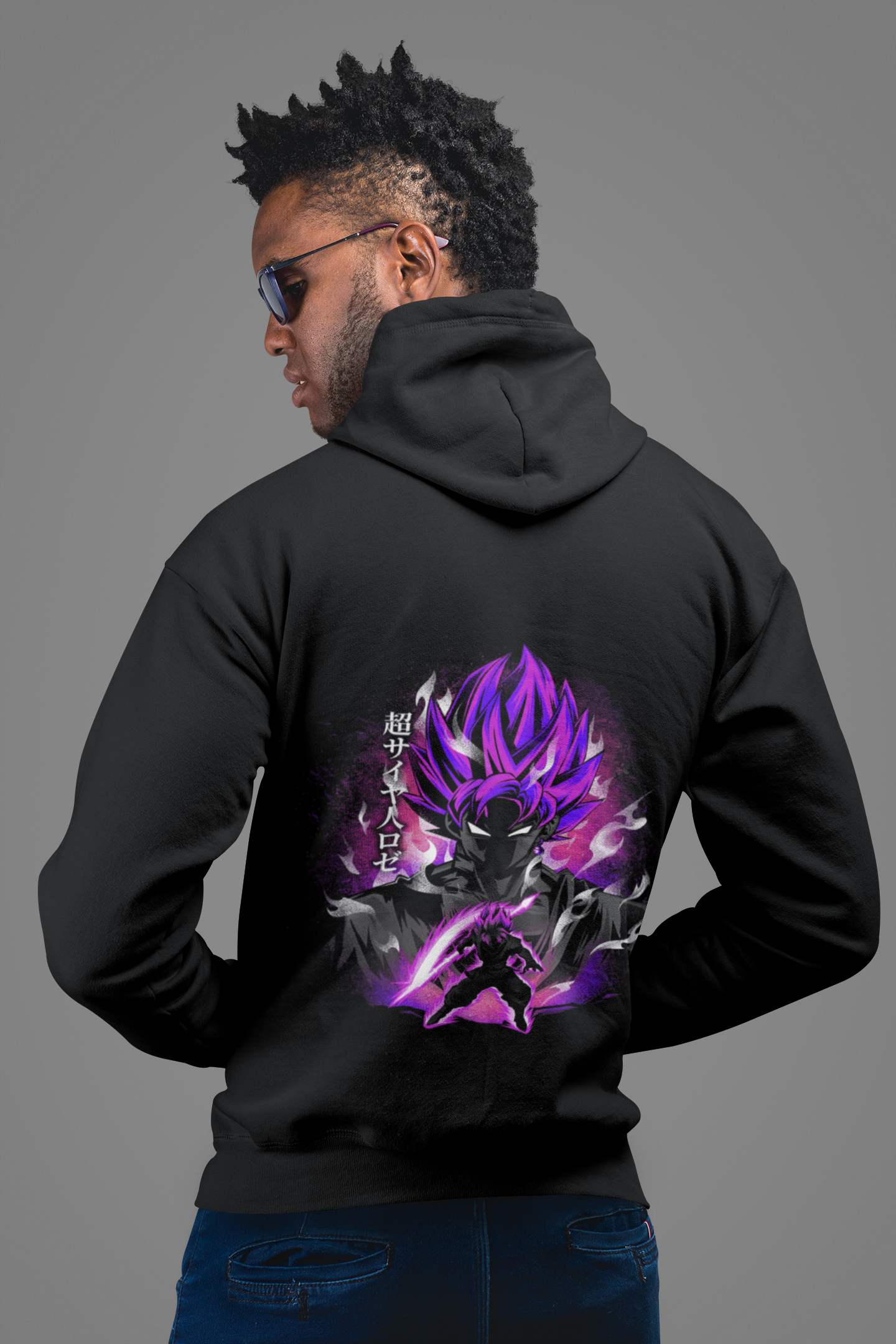 a man wearing a black hoodie with a dragon on it