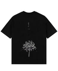 a black t - shirt with a flower on it