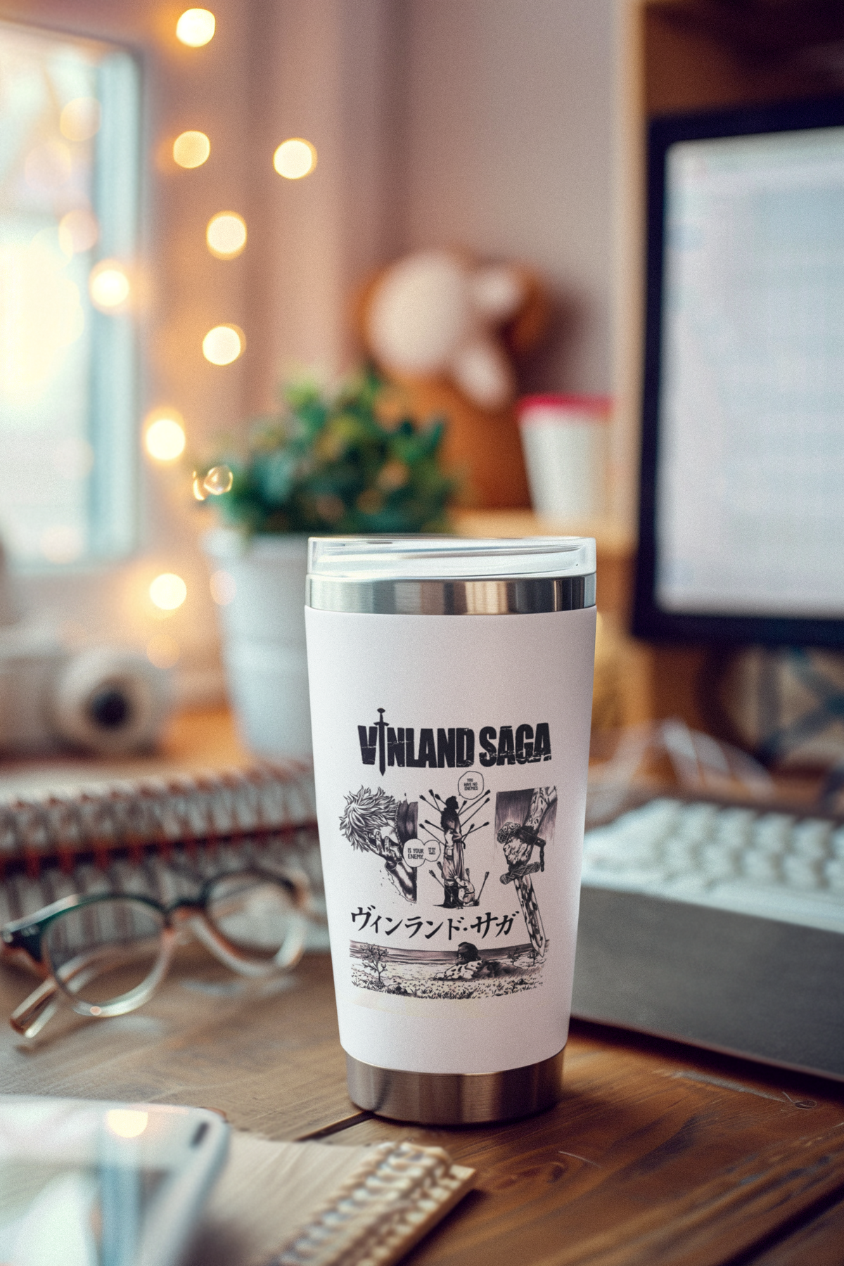 a coffee cup sitting on a desk next to a computer