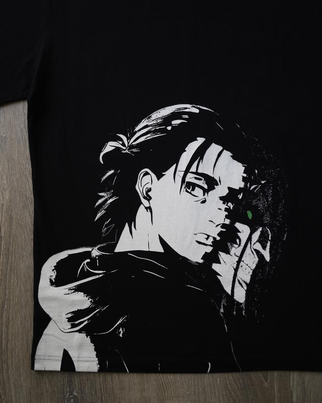 a black t - shirt with a picture of a man holding a gun