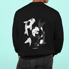 a man wearing a black sweatshirt with white fish on it