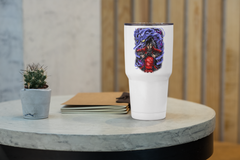 a white cup sitting on top of a table next to a plant