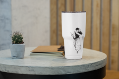 a white coffee cup with a picture of a man on it