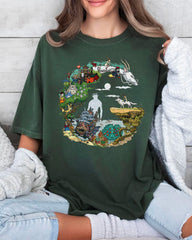 a woman wearing a green t - shirt with a picture of animals on it