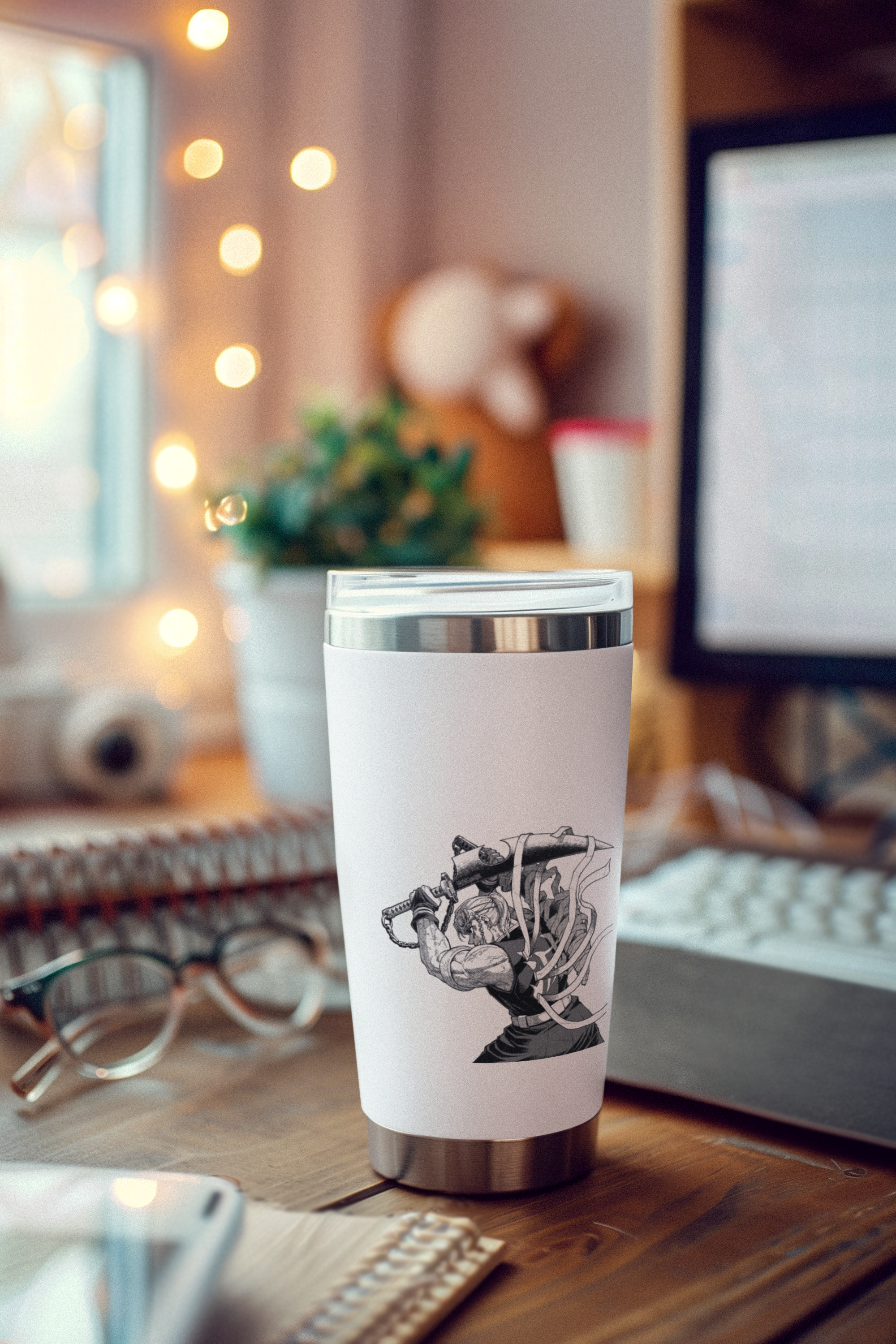 a coffee cup sitting on a desk next to a computer